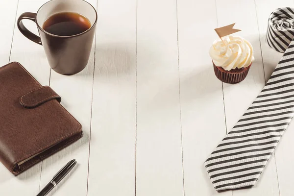 cupcake, tie and notebook