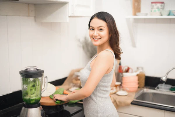 Asian woman making smoothie