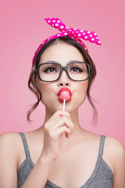 Asian woman eating lollipop — Stock Photo, Image