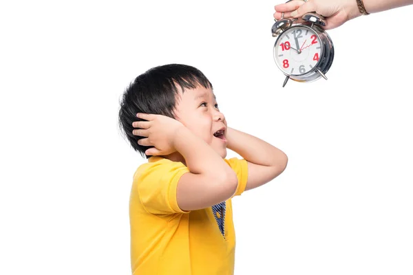 Shocked pupil with big alarm clock giving from his mom. Stock Picture