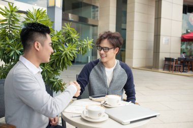 Onun ortağı ile tokalaşırken işadamı