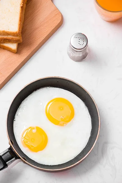 Fried eggs on frying pan. — Stock Photo, Image