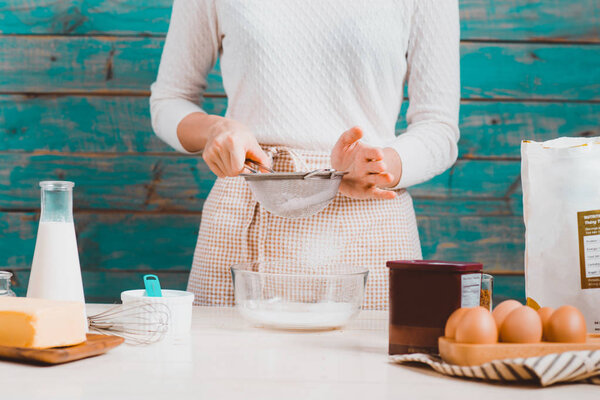 woman preparing dough for cake.