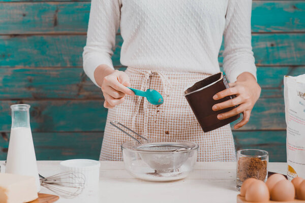 woman preparing dough for cake.