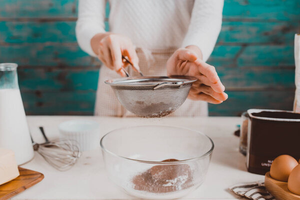 woman preparing dough for cake.