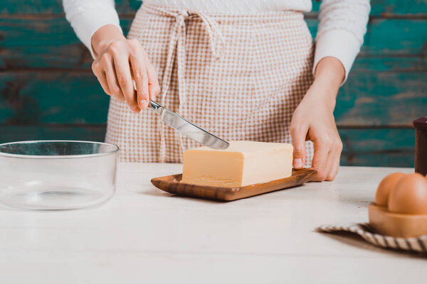 woman cutting butter