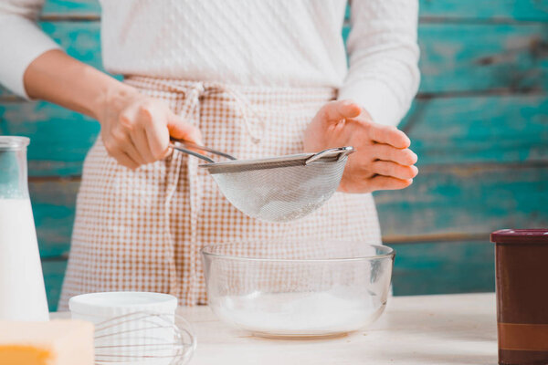 woman preparing dough for cake.