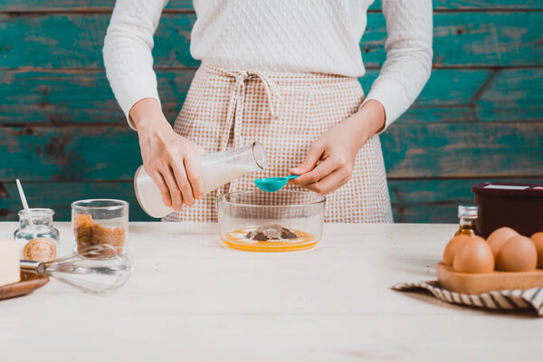 woman preparing dough for cake.