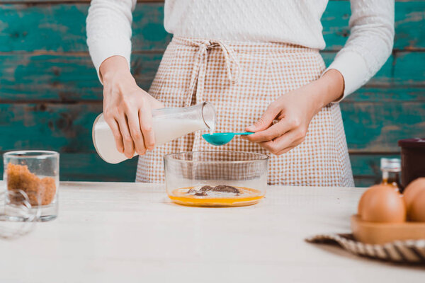 woman preparing dough for cake.
