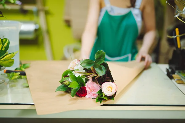 Floristería femenina haciendo hermoso ramo en la tienda de flores —  Fotos de Stock