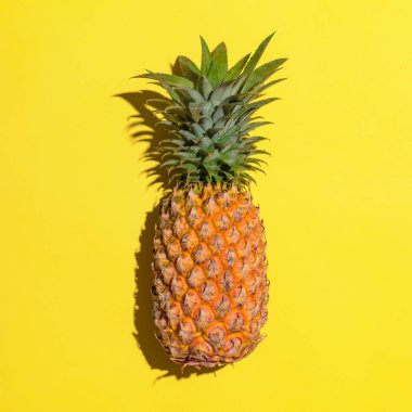 Sarı arka planda ananas.