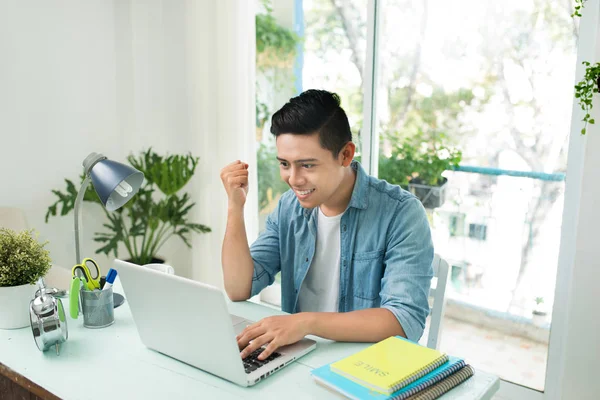 Retrato de animado asiático jovem homem de negócios trabalhando no laptop c — Fotografia de Stock