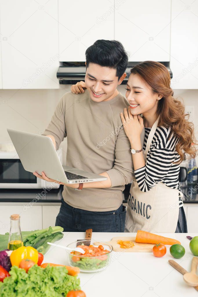 couple using laptop to look up recipe