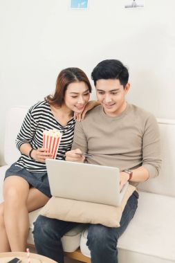 kendi oturma odasında televizyon izlerken rahat genç Çift