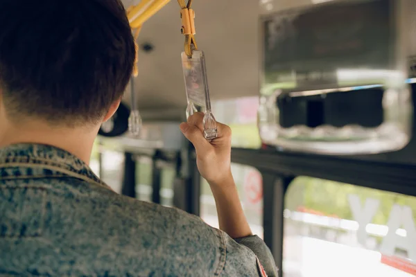 Male hand holding onto a handle of bus — Stock Photo, Image