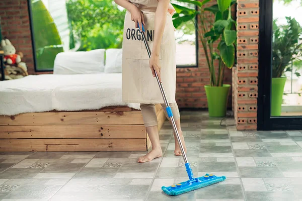 Housework and housekeeping concept. Woman cleaning floor with mo — Stock Photo, Image