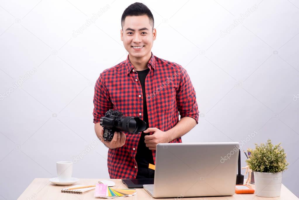 Professional photographer holding camera