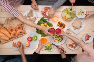 bir grup insan yemek yerken 