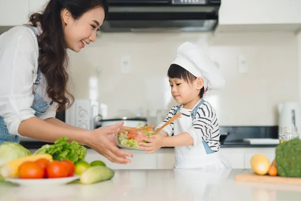 Mother and daughter cooking vegetables — Stock Photo, Image