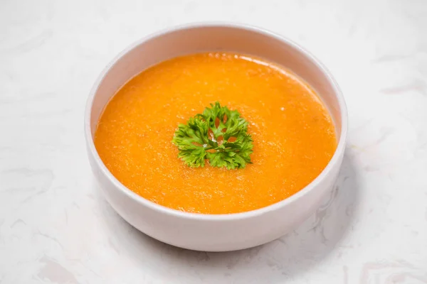 Carrot soup with cream and parsley — Stock Photo, Image