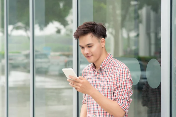 Social media communication. Casual man making video call using mobile smart phone outdoors