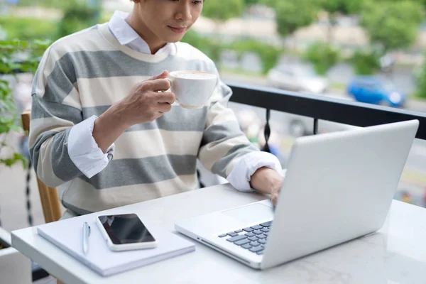 Mann trinkt Kaffee und arbeitet am Laptop — Stockfoto