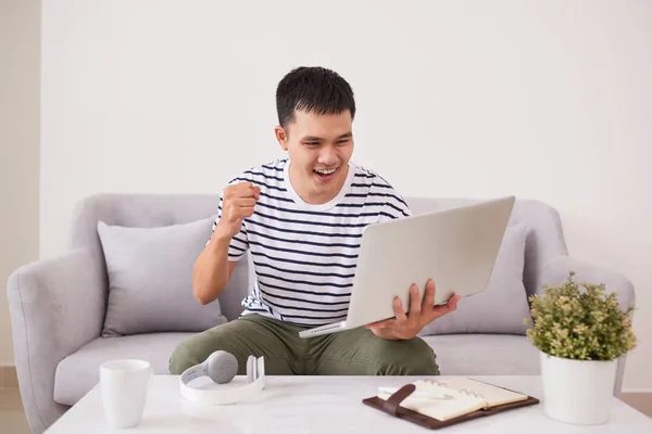 Cheerful Businessman Sitting Couch Home Using Laptop Joyful Raising His — Stock Photo, Image