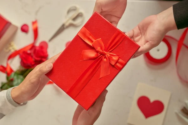 Hands Giving Receiving Red Present Top View — Stock Photo, Image