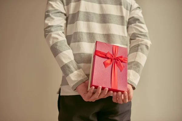 Man Standing Holding Red Gift Box His Back — Stock Photo, Image