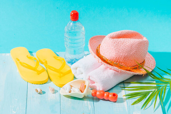 Summer holiday with beach accessories on blue background.