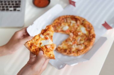 Kola ve dizüstü bilgisayar, lokanta ile ofis masasında lezzetli pizza