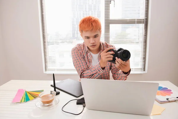 Photographer working at desk in modern office