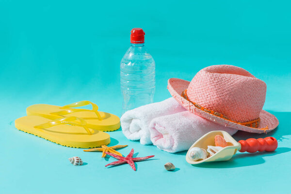 Summer beach vacation and accessories on blue background.