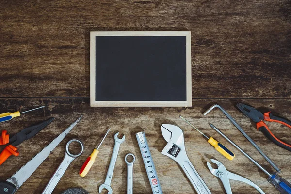 Labor day. Construction tools with blank chalkboard