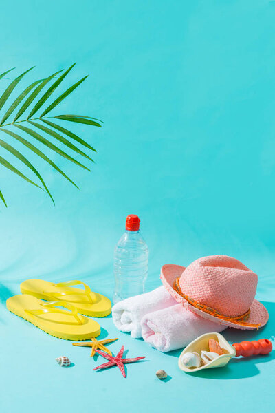 Summer beach vacation and accessories on blue background.