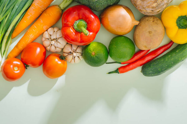 Various fresh vegetables on a wooden table. Top view.