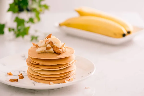 Bananas, cashews and pancakes and caramel sauce.