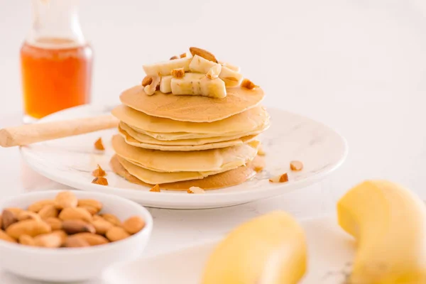 Banana cashew pancakes with bananas and caramel sauce.