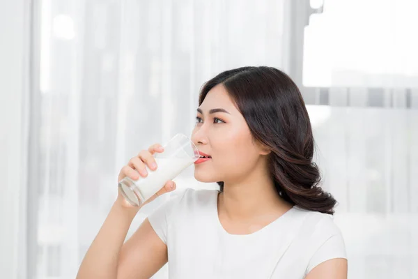 beautiful asian woman drinking milk