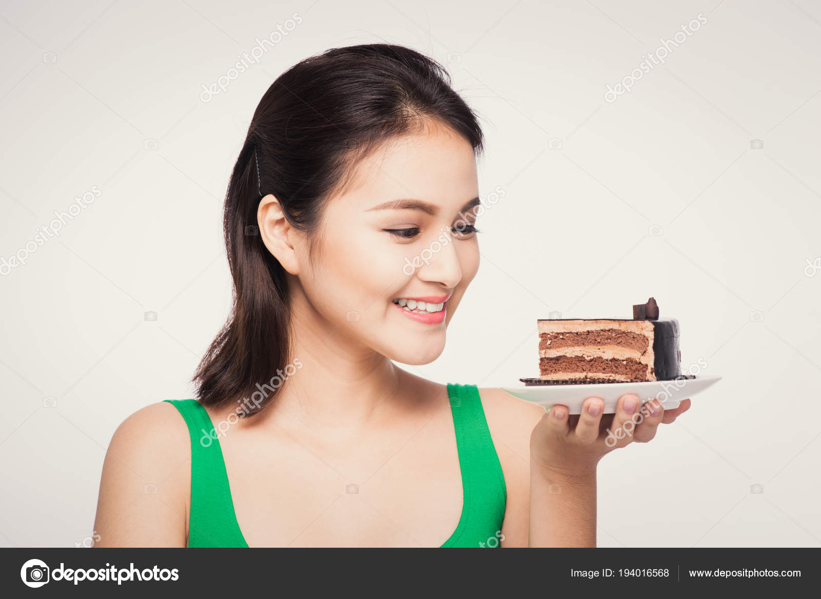 Beautiful Asian woman eating tasty chocolate cake. Teen girl eating the cake.  Stock Photo | Adobe Stock