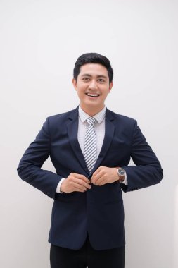 Elbise üzerinde koyarak genç gülümseyen yakışıklı işadamı portresi Waistup