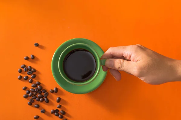 Taking Green Cup Coffee Coffee Beans Orange Background — Stock Photo, Image