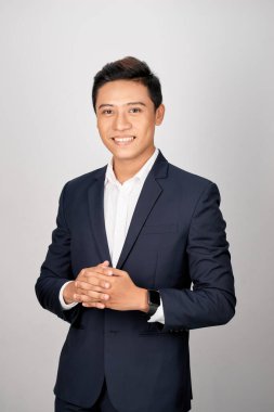 Beyaz arka planda duran ofis elbiseli Asyalı adam.