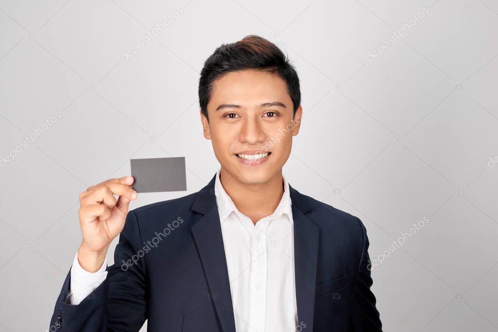 Portrait of young asian man showing a visit card