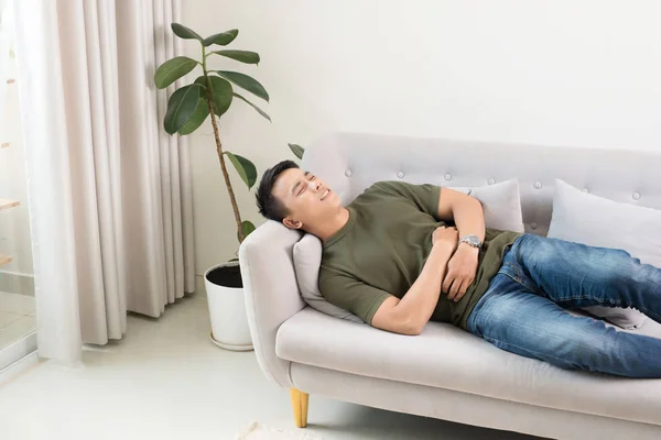 Man Clutching His Stomach Acute Pain Lying Couch — Stock Photo, Image
