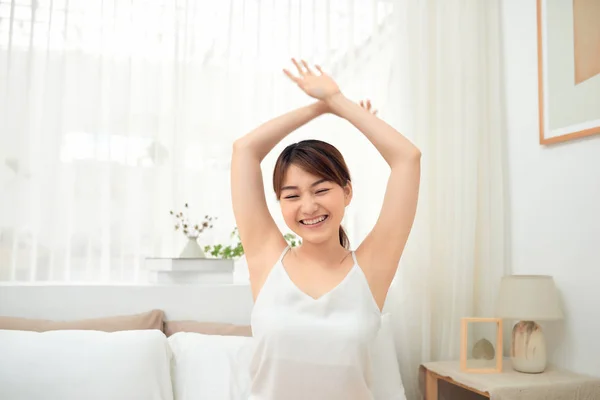 Happy Asian Girl Waking Stretching Arms Sitting Bed Morning — Stock Photo, Image