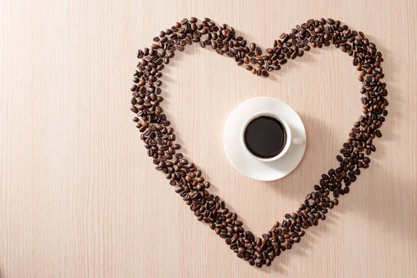 Kavrulmuş Fasulyeli Kahve Fincanı Ahşap Arka Planda Aşk Şekilleri — Stok fotoğraf