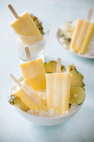 Some homemade Pineapple Popsicles (selective focus) on a rustic background