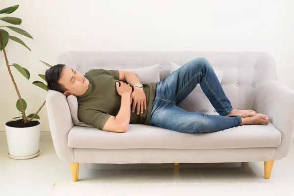 Man Clutching His Stomach Acute Pain Lying Couch — Stock Photo, Image