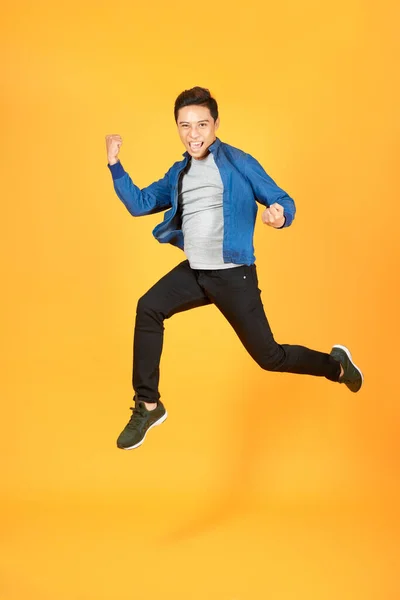 Young Happy Asian Teen Jumping Welcomely Isolated Orange Studio Background — Stock Photo, Image